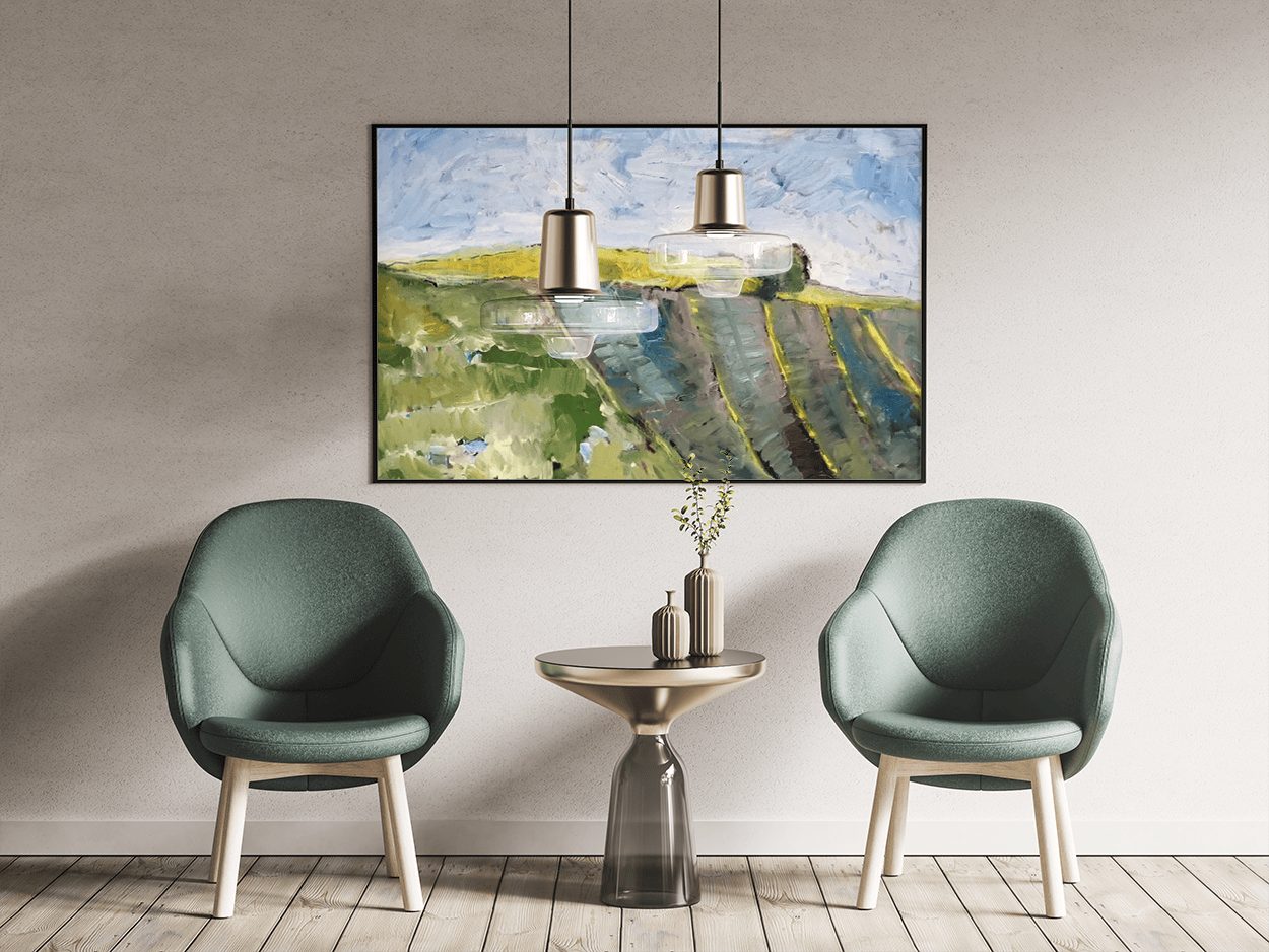 A Monica Cohn landscape between two green armchairs